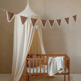 Tulle canopy with pompoms